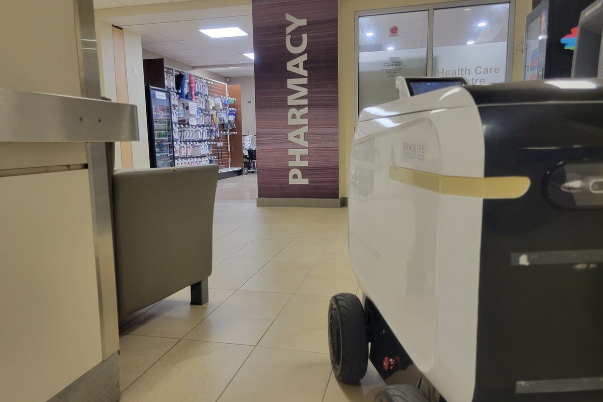 A delivery robot operating unattended inside a hospital building