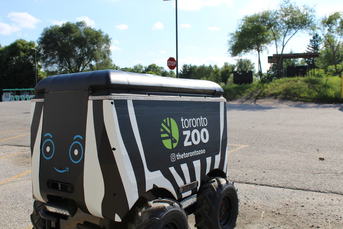 A Toronto Zoo branded delivery robot on a paved path